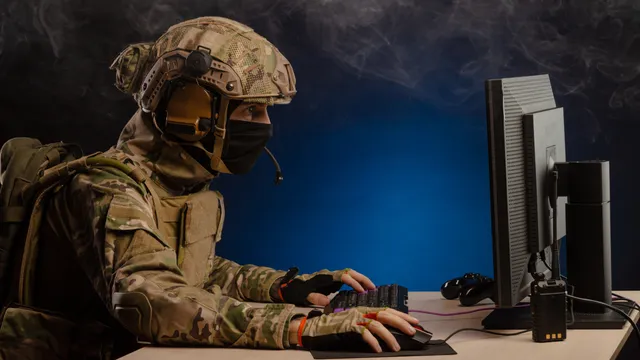 Military operator at computer terminal representing cyber warfare threat