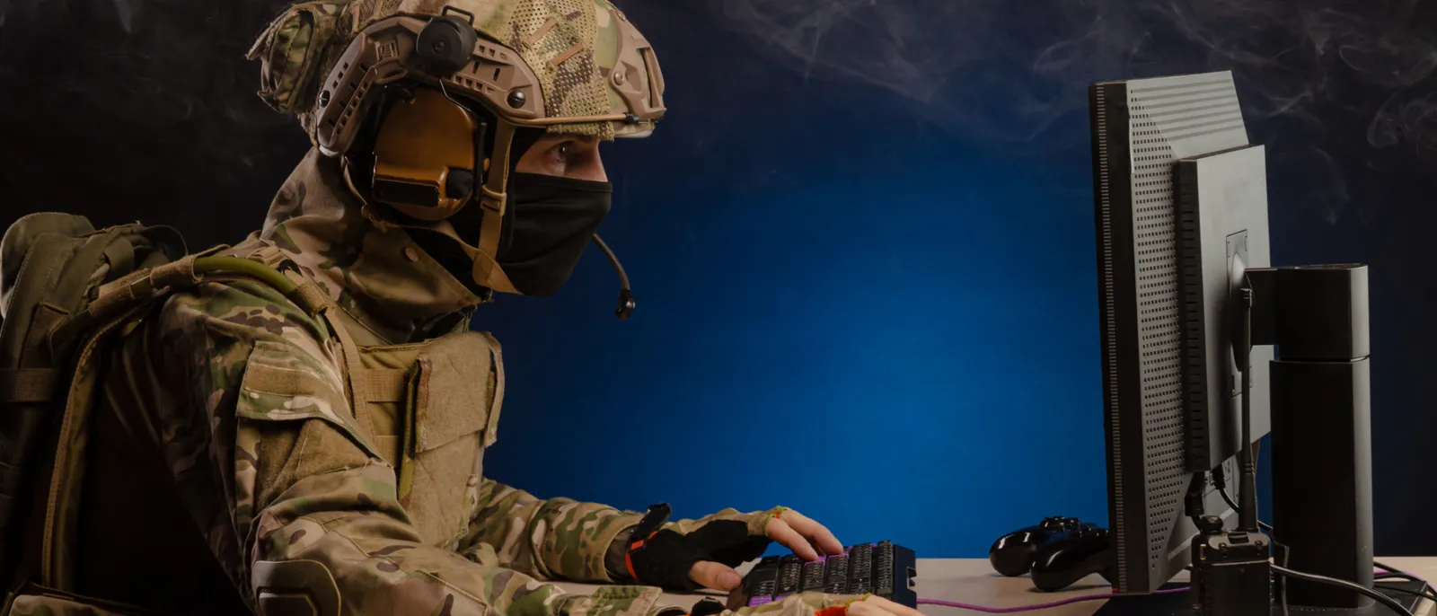 Military operator at computer terminal representing cyber warfare threat